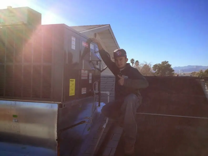 HVAC technician performing Air Duct Repair on a rooftop unit in National City